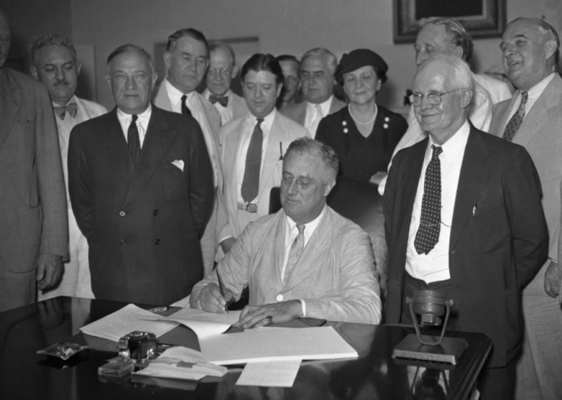 1935: Franklin D. Roosevelt signs Social Security Bill