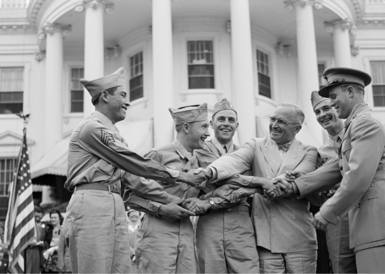 1946: President Harry S. Truman congratulating servicemen