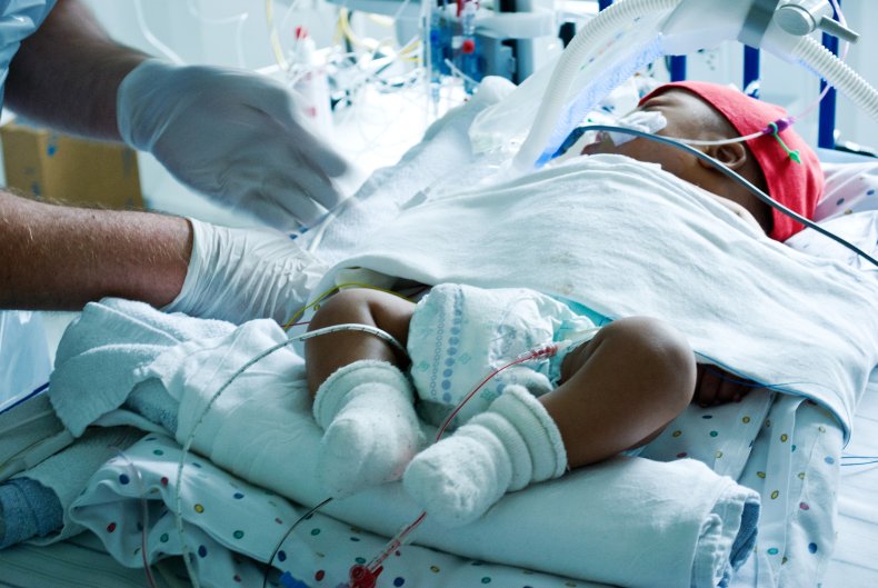 Sick baby treated by doctor in ICU