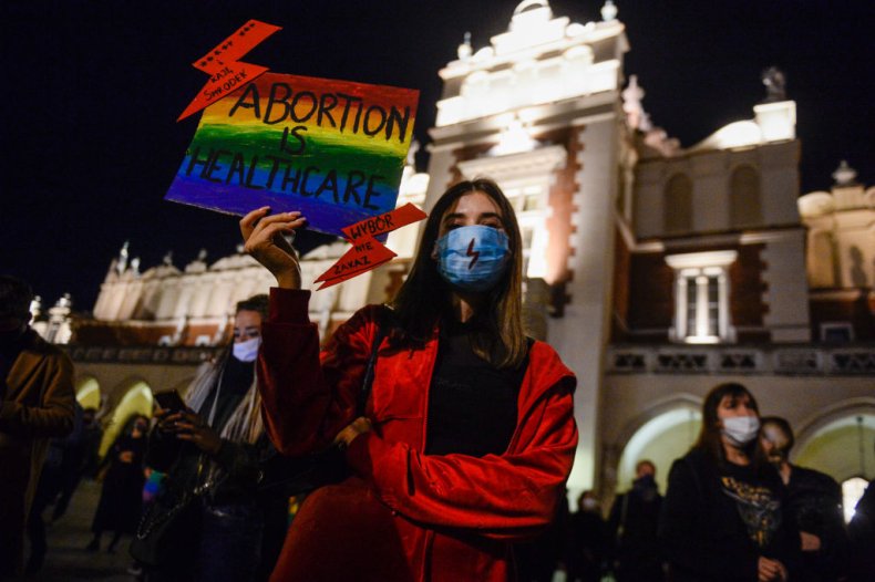 Poland abortion protester holds sign in Krakow