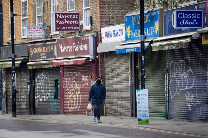 A man walks past closed shops London