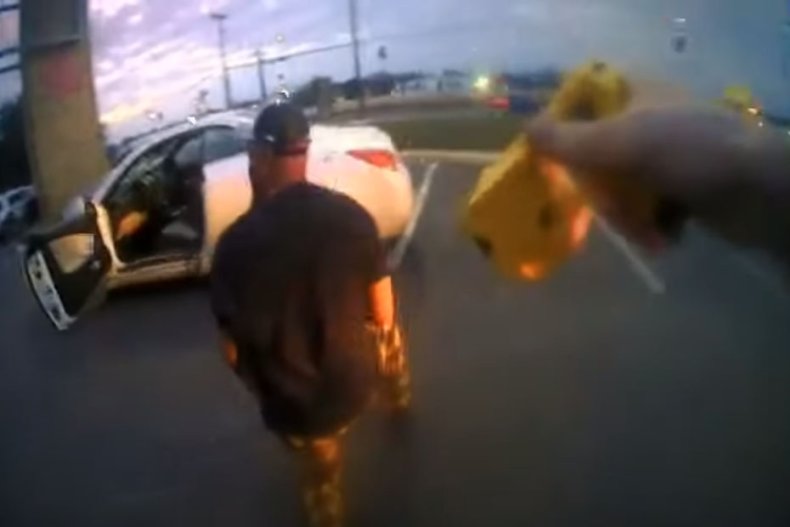 Police officer Kaleb Meyer arrests Clarence Crawford