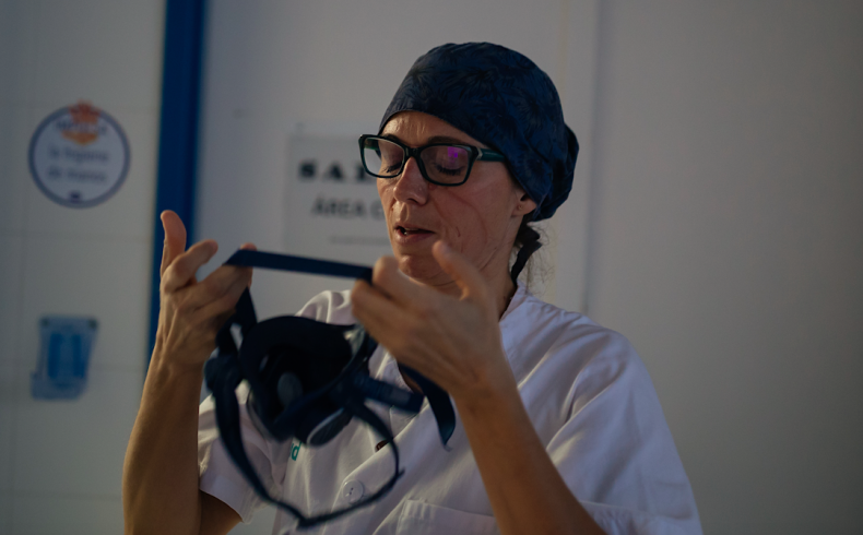Medical worker putting on mask
