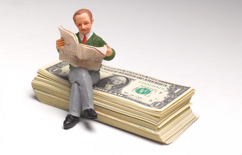 Pensioner sitting on stack of US Dollars