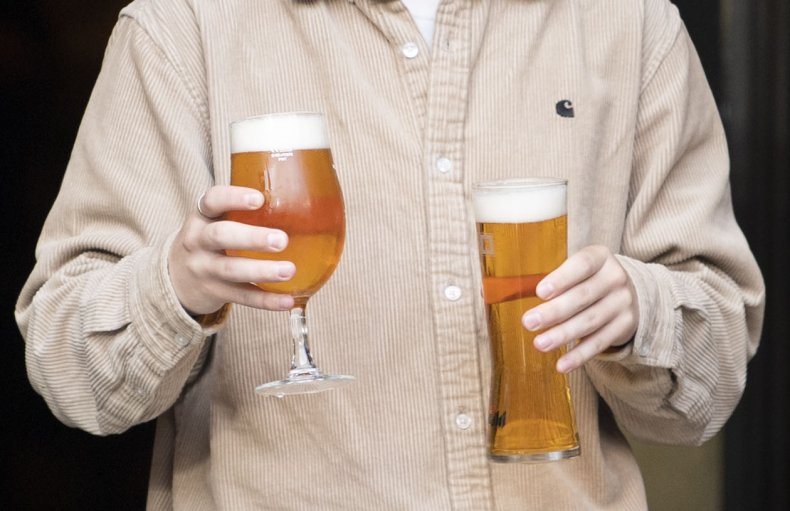 Worker carries two beers