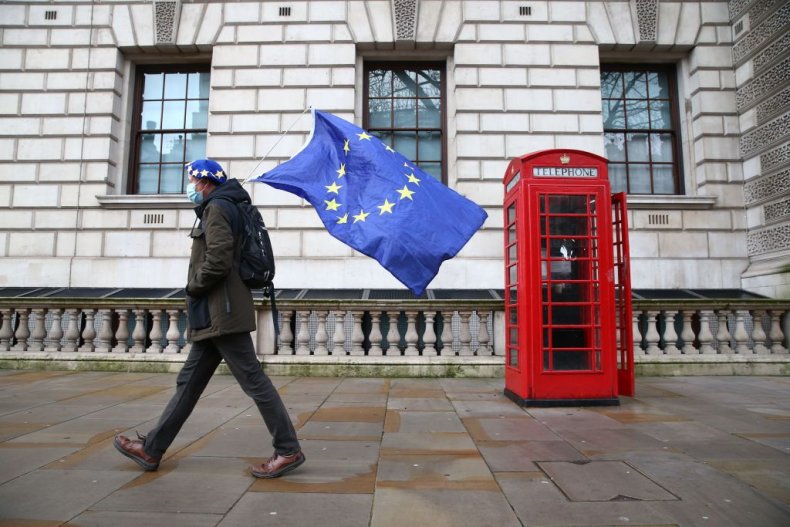 Man carrying EU flag by London phonebox