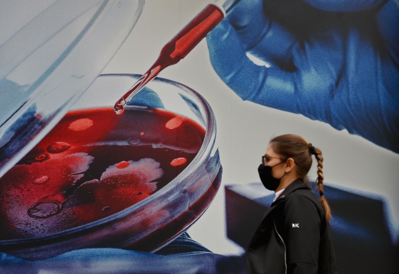 person walks past pfizer vaccine hq