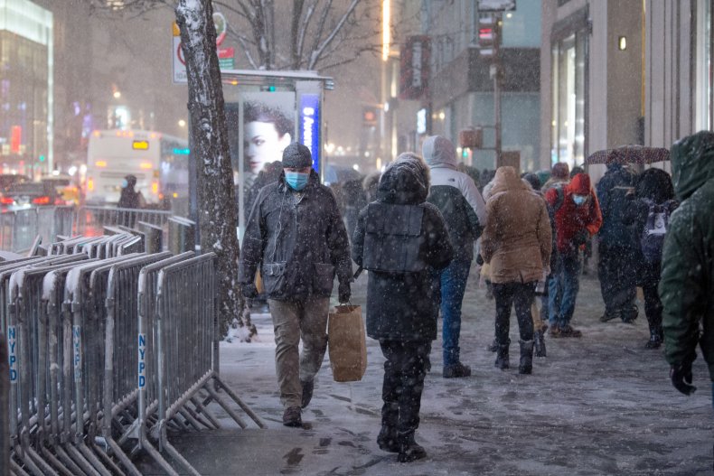 man wearing mask walks through new york