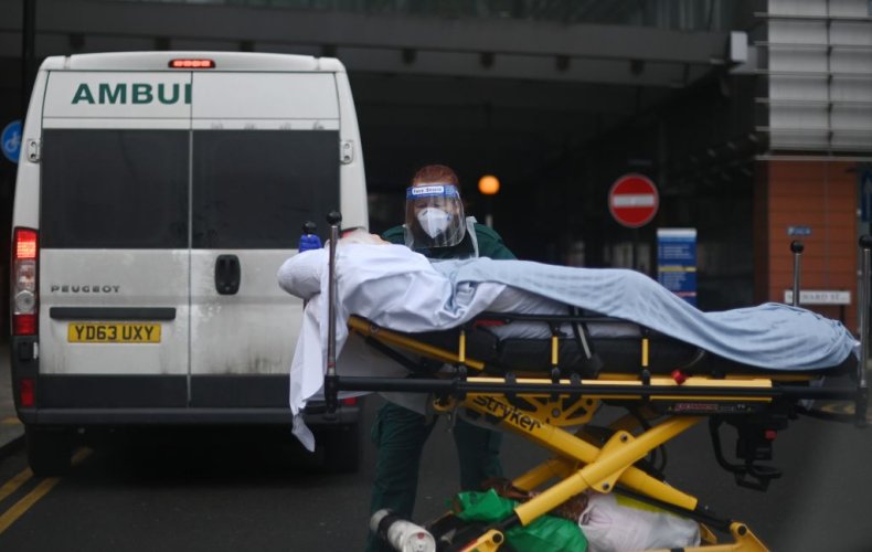 Patient is wheeled from ambulance London UK