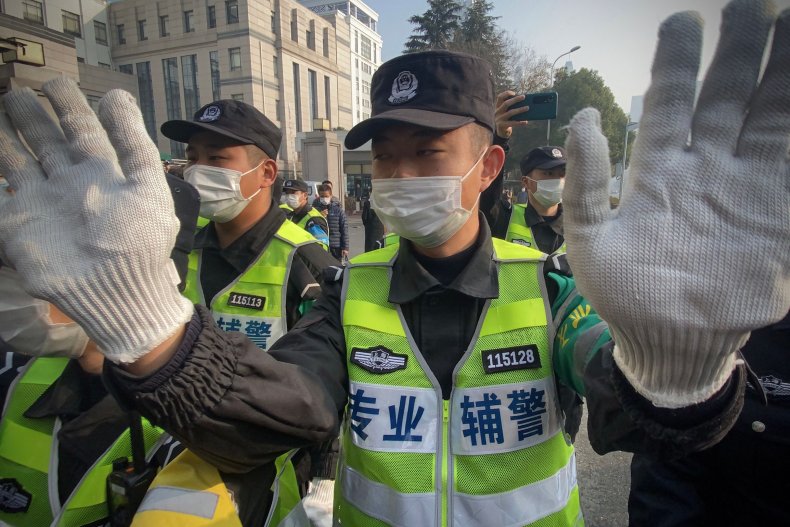 Chinese police outside trial of COVID journalist