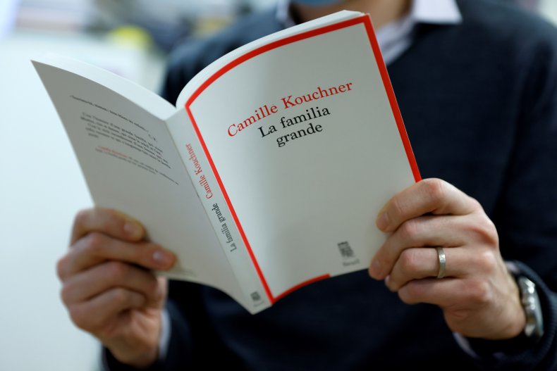 A man reads Camille Kouchner's book