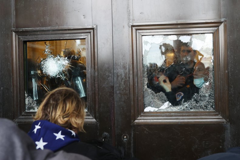Capitol police officer looks through window