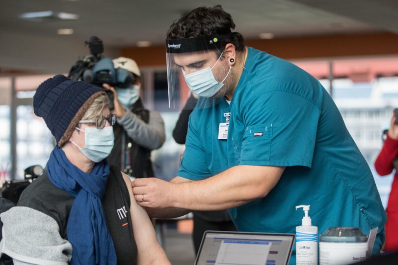 A healthcare worker administers the COVID-19 vaccine