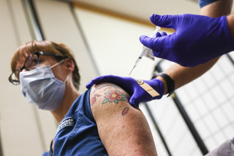 nurse receives Pfizer-BioNTech COVID-19 vaccine