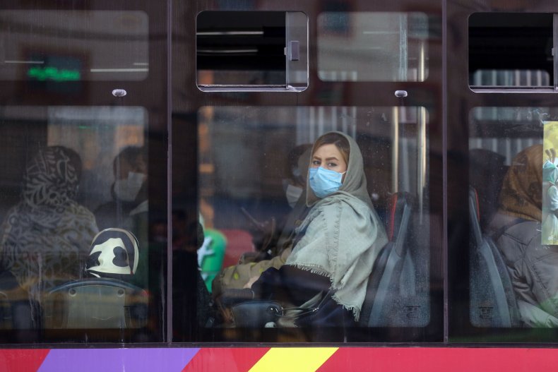 Iran woman on bus in Tehran mask