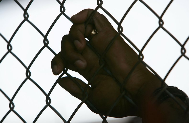 Louisiana State Penitentiary inmate holds fence