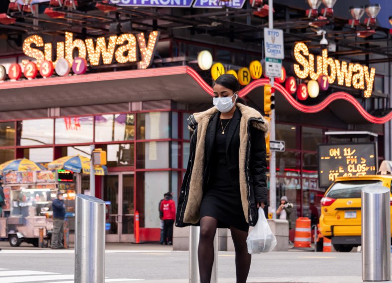 Person Wearing a Mask in Times Square