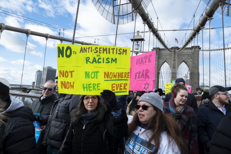 Woman carries sign during solidarity march