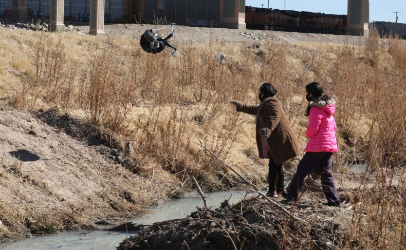 Migrants cross the Rio Bravo