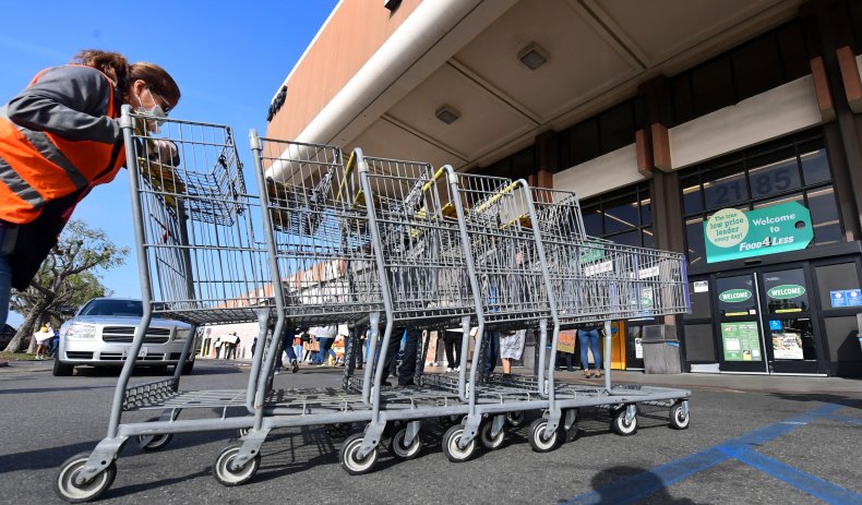 Food 4 Less worker pushing carts