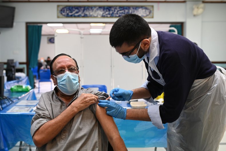 Health worker administers COVID-19 vaccine