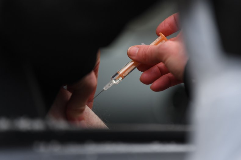 Health worker administers a COVID-19 vaccine