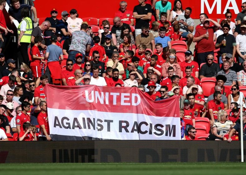 Manchester United fans display an anti-racism banner