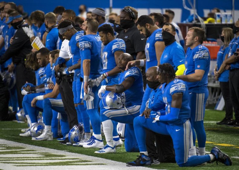 Detroit Lions players kneel during the national anthem