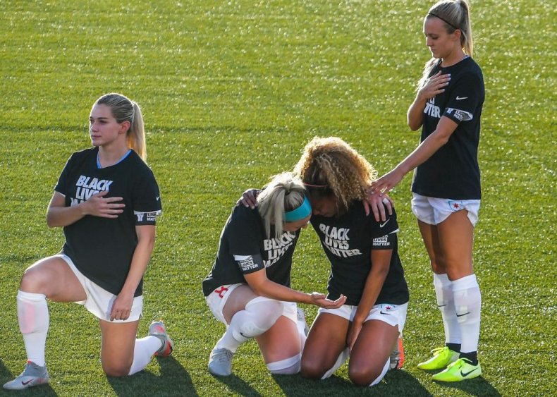 Chicago Red Stars’ Casey Short and teammate kneel