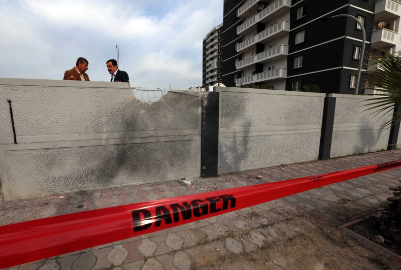 Men stand near Erbil rocket attack site