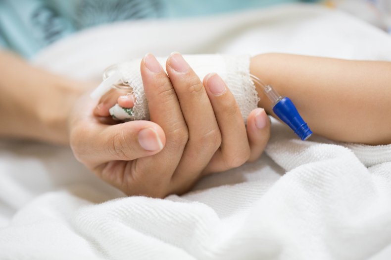 Mother holding a baby's hand in hospital