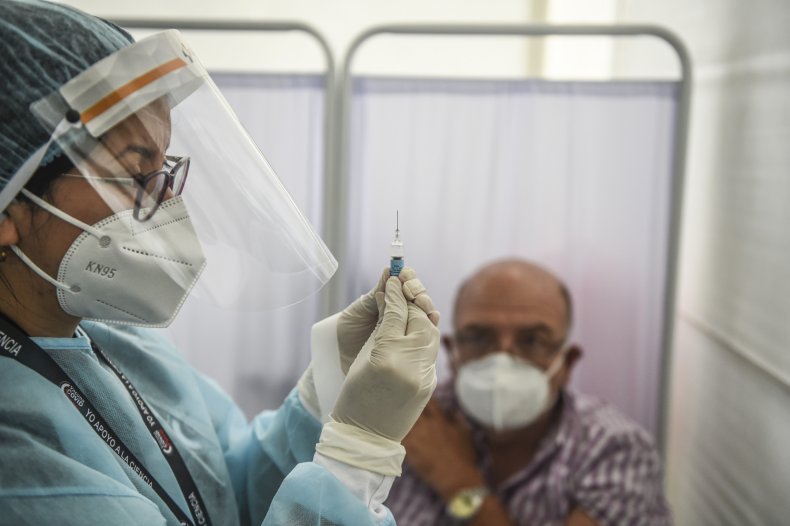 Health worker holding syringe