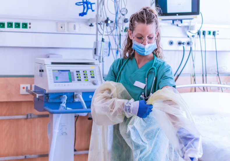 Nurse putting on PPE