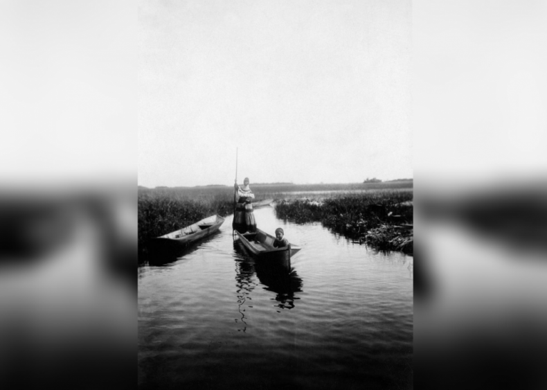 Seminole woman canoeing in the Everglades