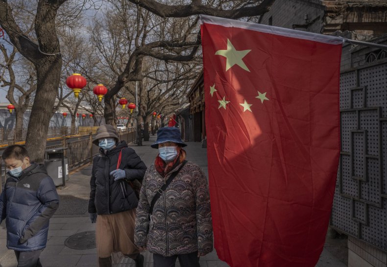 Chinese people pictured with flag in Beijing