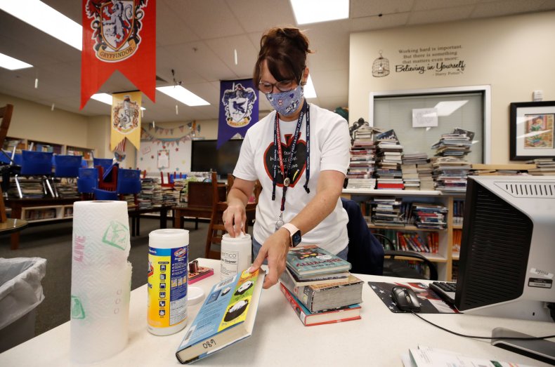 A librarian cleans books