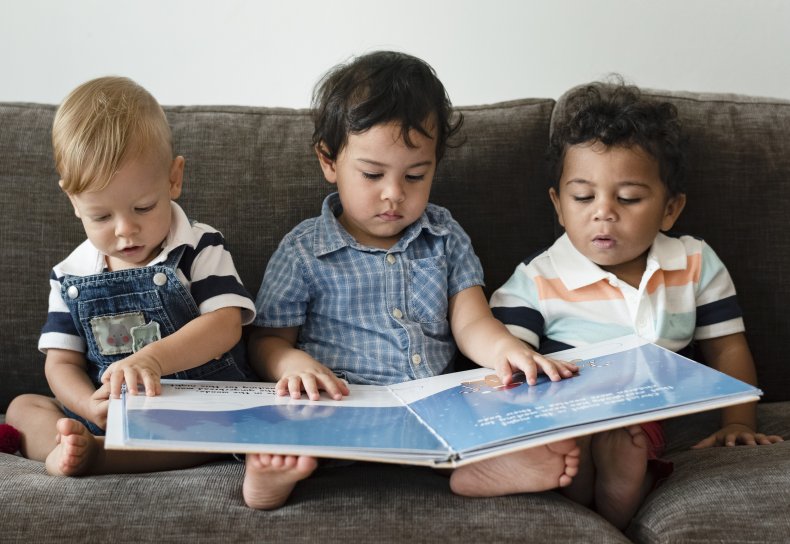 Babies reading a book