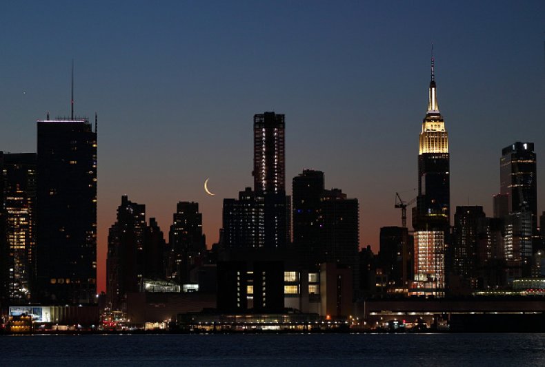 A crescent moon rises behind the Empire