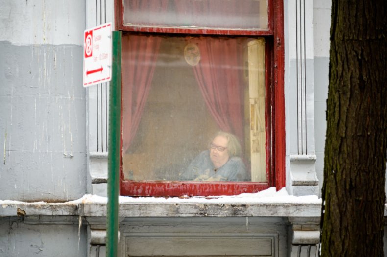 Person looks out window