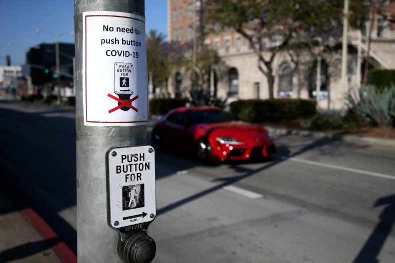 Signs are seen posted above crosswalk buttons