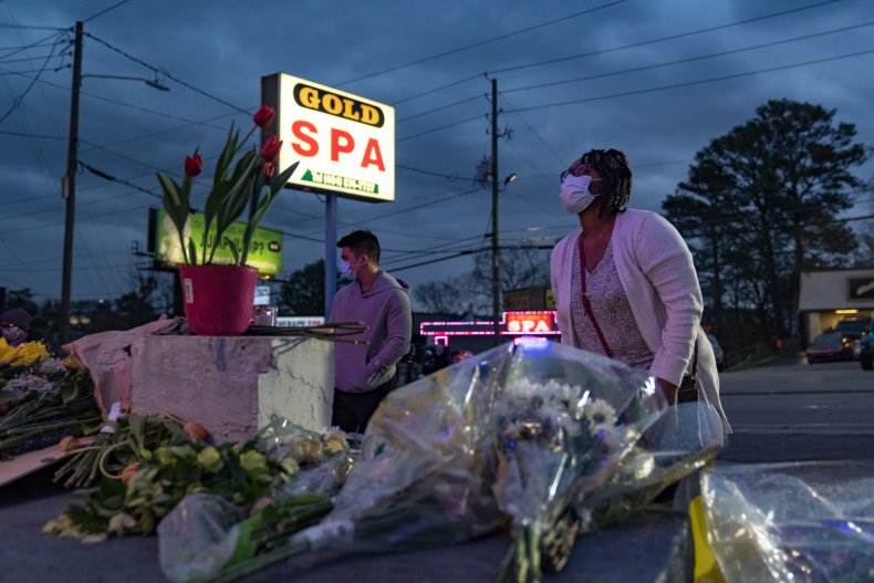 People leave flowers outside Atlanta spa