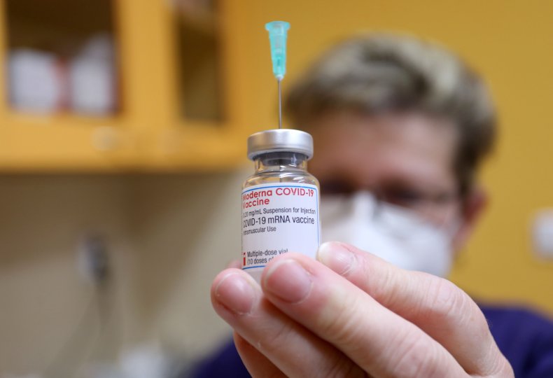 Moderna vaccine vial held to camera