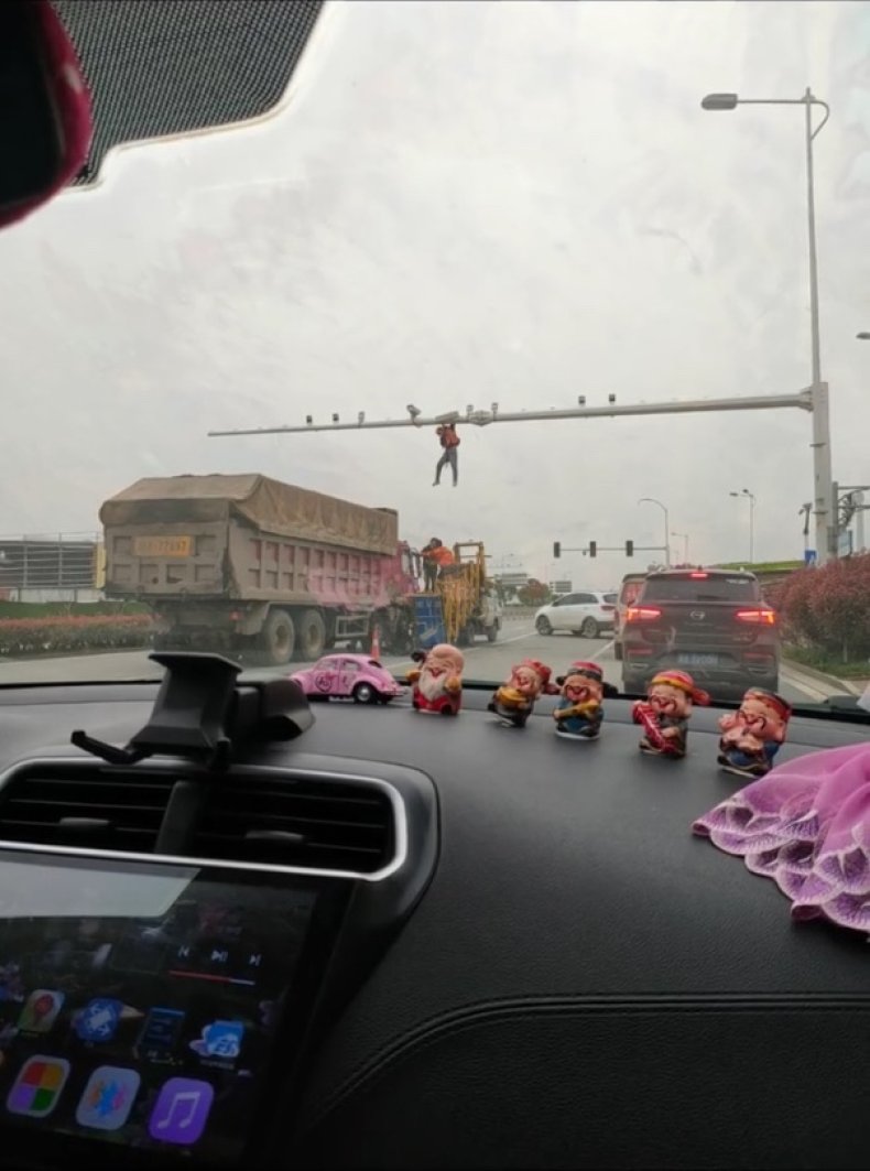 Repairman Dangles From Traffic Camera Rig