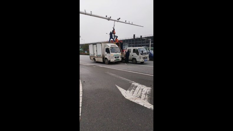 Repairman Dangles From Traffic Camera Rig