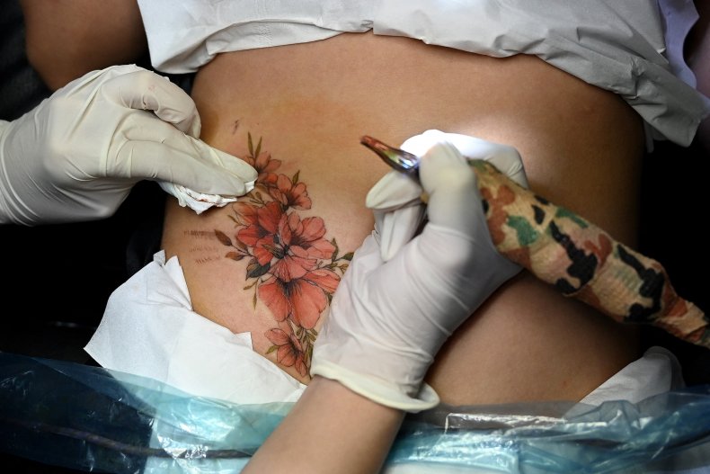 woman gets tattoo