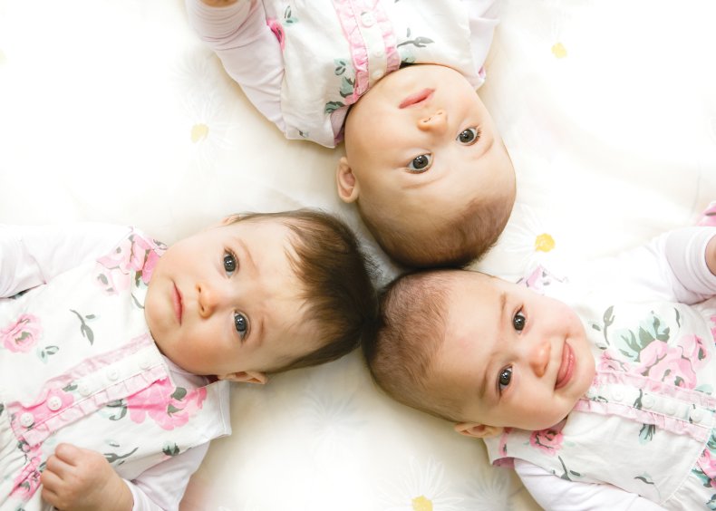 Stock image of triplets lying down
