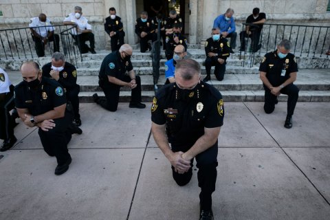 police officers take a knee