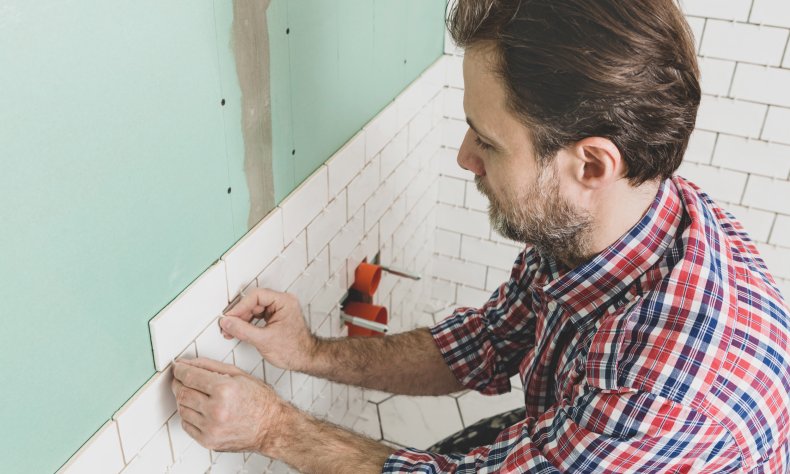 Stock image of a man tiling