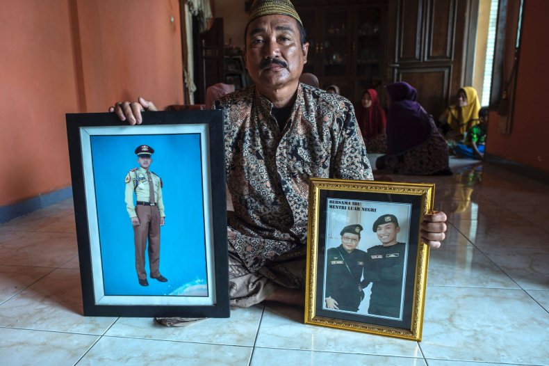 Edy Sujianto shows photographs of his son
