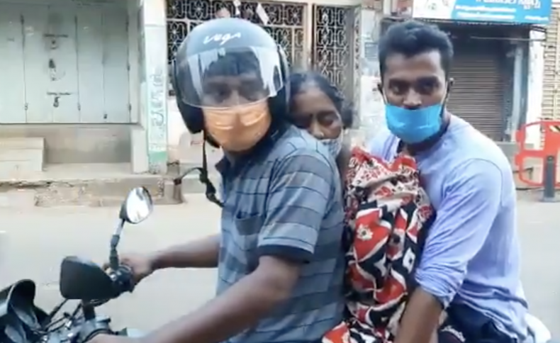 Men in india on motorbike with body